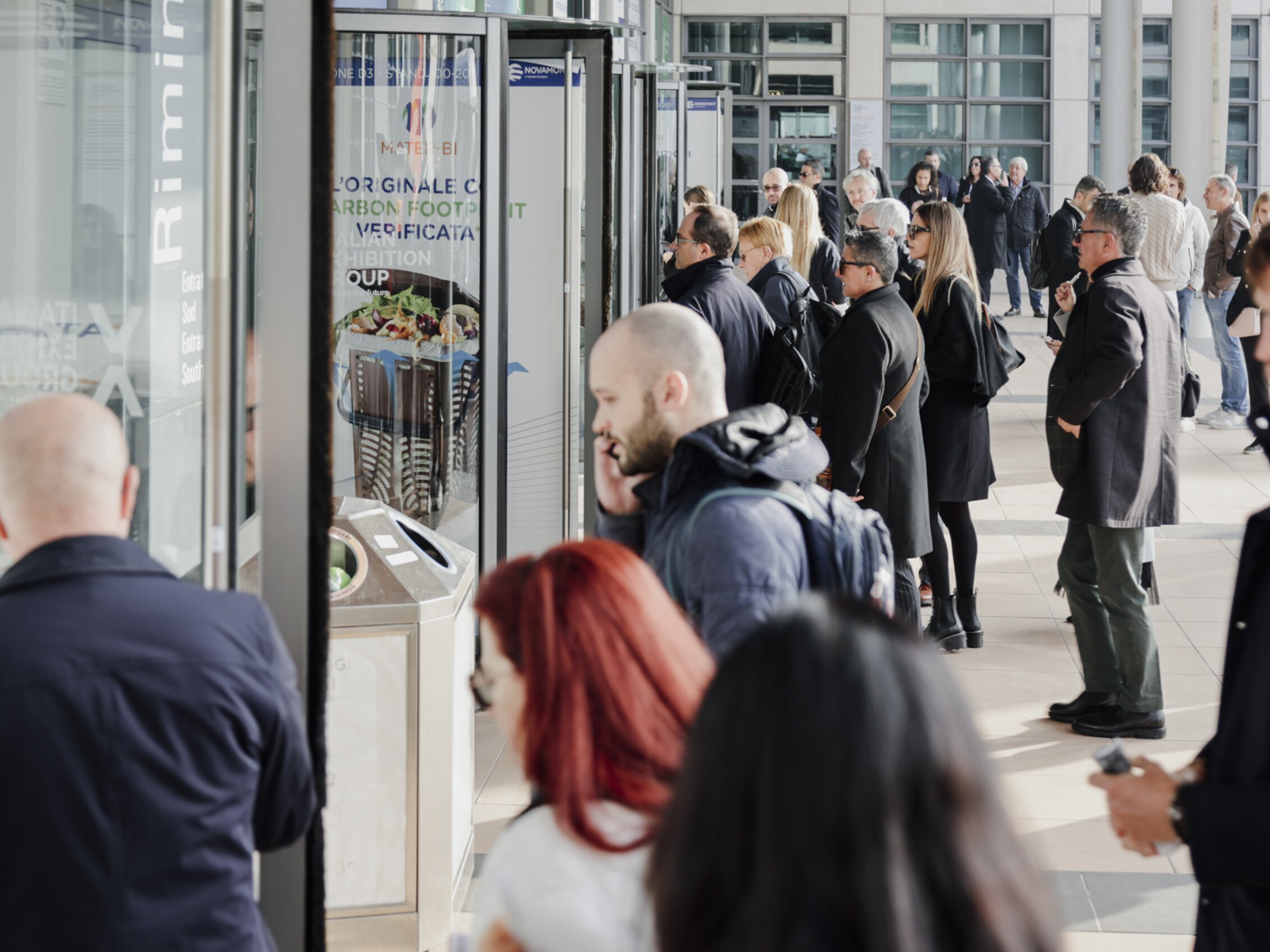 many people are preparing to enter through the revolving doors of the west entrance of the rimini expo centre